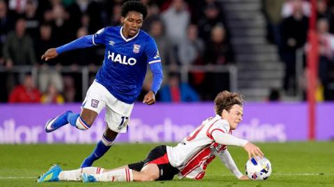 Southampton's Casper Jander hits the deck under pressure from Jaden Philogene