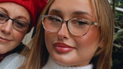 A woman with long blonde hair and glasses with another woman with glasses alongside her