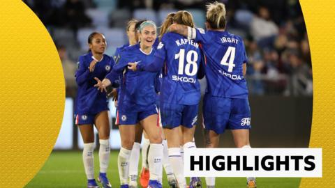Chelsea women's players celebrate in a huddle in blue Chelsea kit