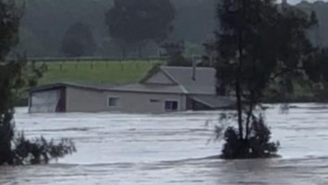 House floating in river