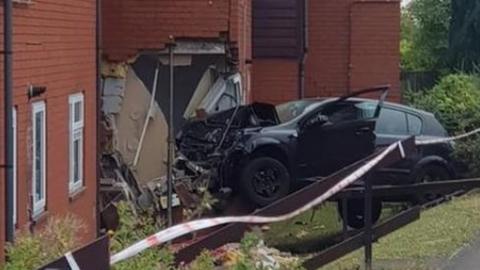 Car crashed into house