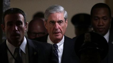 Robert Mueller walks through the halls of Congress.