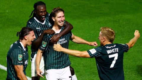 Plymouth players celebrate a goal