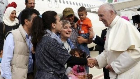 Pope Francis greets refugees