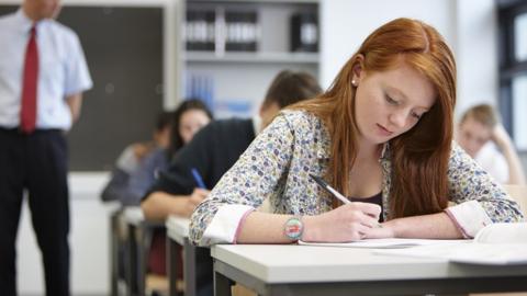 pupils at desks in classroom