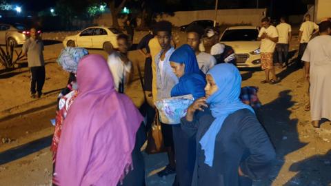 People gather outside the Tajoura Detention Center after an air strike kills nearly 40 migrants east of Tripoli, 3 July