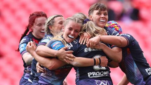 Wigan Warriors celebrate scoring against St Helens in the 2025 Women's Challenge Cup fina