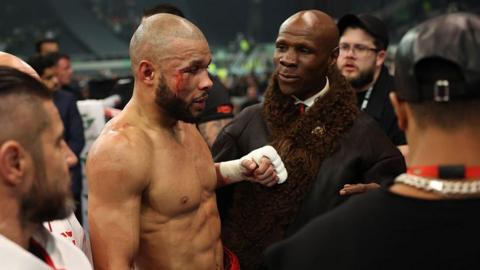 A bleeding Chris Eubank Jr with his father 