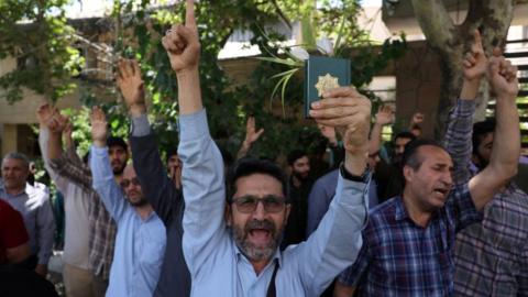 Demonstrators take part in a protest in front of the Swedish Embassy in Tehran