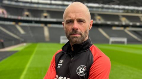 Paul Warne stares directly at the camera