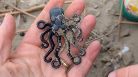 A toy octopus in a hand