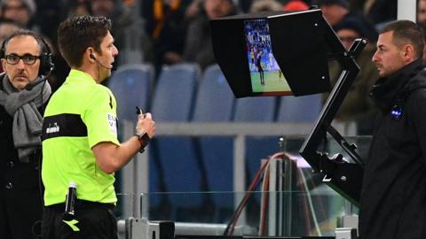 Referee Gianluca Rocchi checks the Video assistant referee (VAR) during the Italian Serie A football match AS Roma vs Lazio on November 18, 2017 at the Olympic stadium in Rome