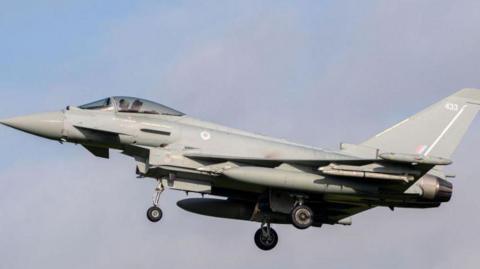 Royal Air Force Eurofighter Typhoon coming into land at RAF Coningsby. It has the number 433 on the tail fin and the RAF's red, white and blue circular emblem behind the cockpit.