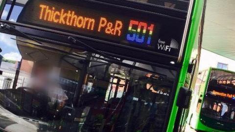 A Norwich Park and Ride bus with rainbow coloured numbers.