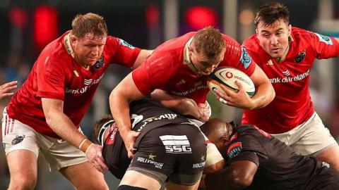 Munster's Gavin Coombes is tackled by Sharks' James Venter