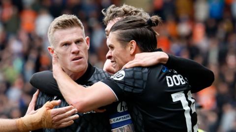 Wrexham's James McClean (left) celebrates scoring for Wrexham with team-mates
