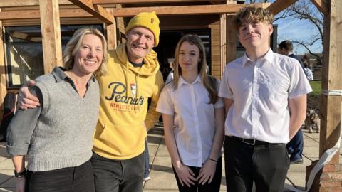 Staff Sarah Nute and Gavin Walker with teenagers Mia and Charlie at The Shed