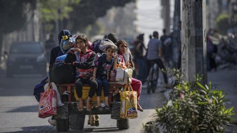 Residents carry their belongings as they evacuate Gaza City amid increased military operations in the Gaza Strip
