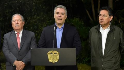 Colombian President Ivan Duque (C) speaks next to Colombian Defense Minister Guillermo Botero (L) and Colombian Attorney General Nestor Humberto Martinez (R)