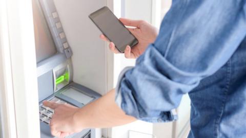 Man using cash machine