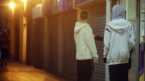 Young people in hooded tops on a housing estate east of Bristol city centre