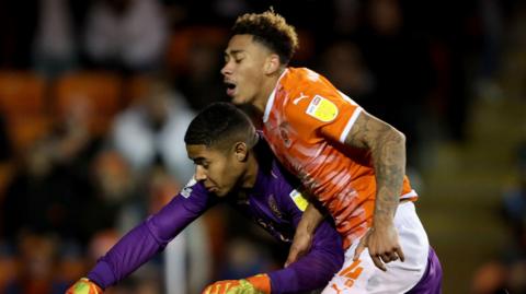 Jordan Gabriel is fouled by QPR's goalkeeper