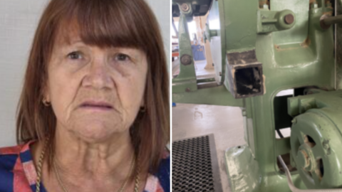 A woman in her sixties with reddish hair. She is staring into the camera. On the right is a green coloured sanding machine.