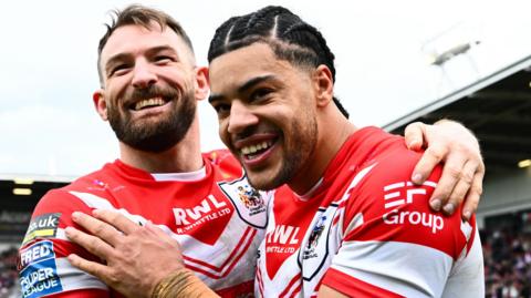 St Helens team-mates Daryl Clark (left) and Lewis Murphy smile and hug after their team's victory over Wigan Warriors on Good Friday
