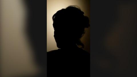 The silhouette of a woman.