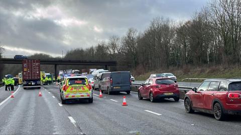 Traffic queuing in a single lane to get past a crash on the M25