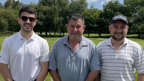 Jamie Murray, his father and his brother, Matt, all wearing polo shirts on a sunny day where they are playing golf.