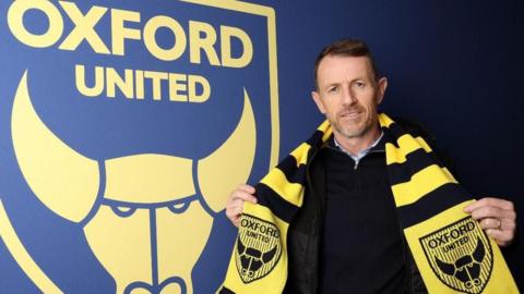 Gary Rowett poses with an Oxford United scarf after being appointed head coach