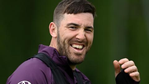 Jamie Overton looks toward the camera