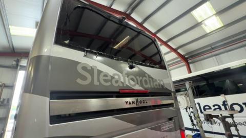 You can see the edge of the glass round the edge of the black rear window of the coach, which is silver and has Sleafordian written on it in a matt light grey colour. 