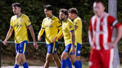 Owen Brain is congratulated after scoring Barry's winner at Holywell