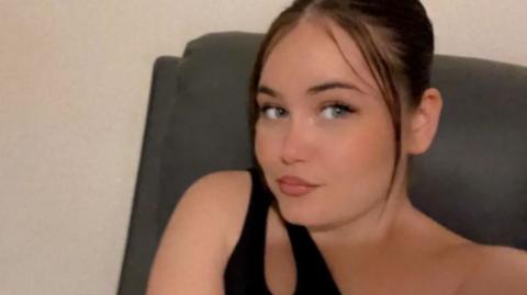 A selfie-style image of Courtney Mitchell. She is looking directly into the camera