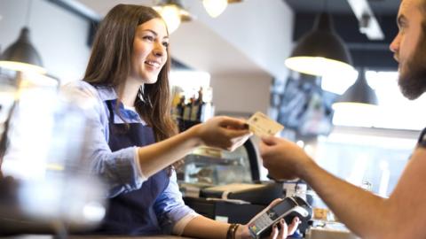 Waitress accepting a customers' payment.