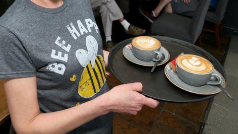 Waitress serving coffee