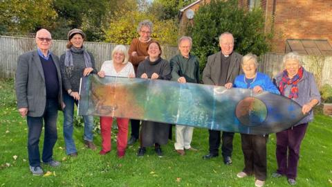 The Dunsden Owen Association committee members with the window designer Natasha Redina and the Revd Robert Thewsey