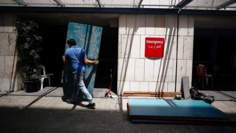 A man fixes damages at the Saint George Hospital University Medical Center, after a massive blast in Beirut"s port area, Lebanon, August 11, 2020.