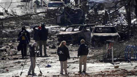 Investigators work near the site of an explosion in Nashville, Tennessee