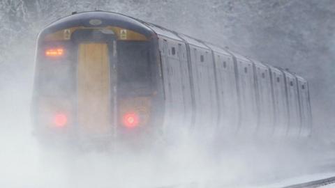 A train in Ashford travels through freezing fog