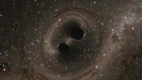 Artists impression of two black holes locked in a “death spiral”