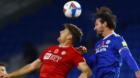 Chris Martin of Bristol City and Sean Morrison of Cardiff City challenge each other in the air