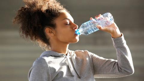 Woman drinking from a water bottle