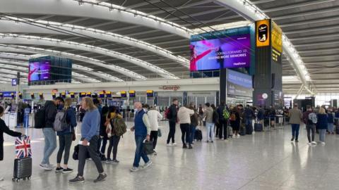 Photo dated 23/04/22 of passengers queuing to go through security in departures at Terminal 5 of Heathrow Airport, west London