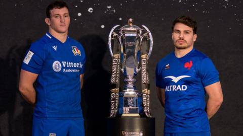 Italy captain Michele Lamaro stands next to the Six Nations trophy with his France counterpart Antoine Dupont