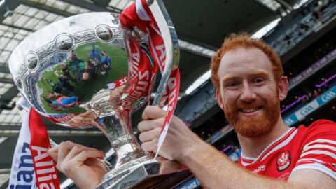 Derry captain Conor Glass celebrates with the Division One trophy