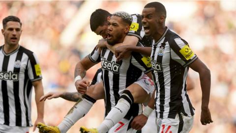 Newcastle players celebrate scoring a goal