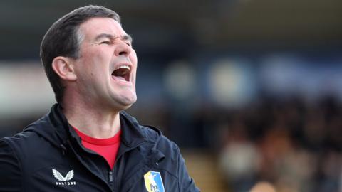 Mansfield Town boss Nigel Clough shouts instructions to his players